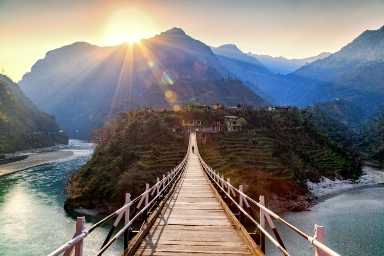 bridge across lush landscape with mountain views