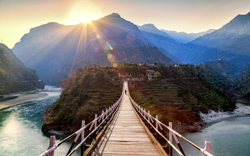 bridge across lush landscape with mountain views