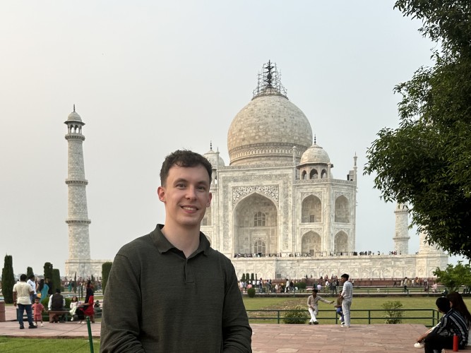 Cameron standing in front of Taj Mahal in the background