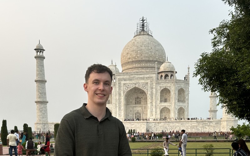 Cameron standing in front of Taj Mahal in the background
