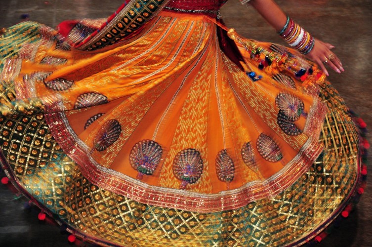 Dancing girl colourful costume during navratri festival celebration