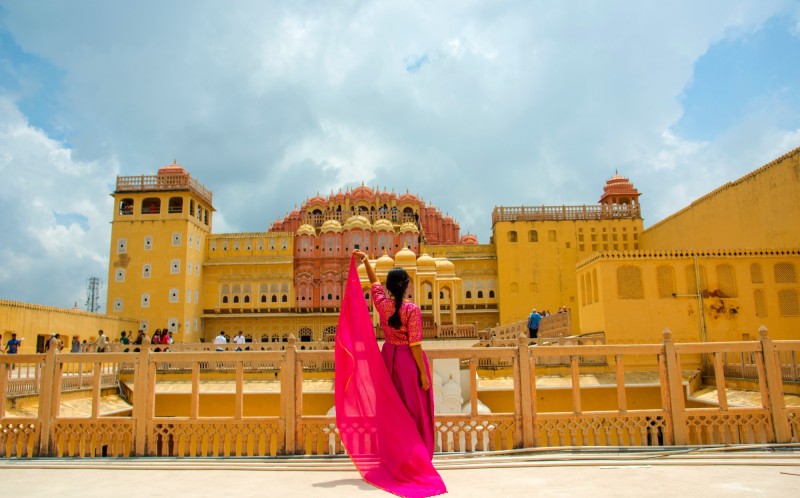 Jaipur palace of the wind with woman in colourful sari