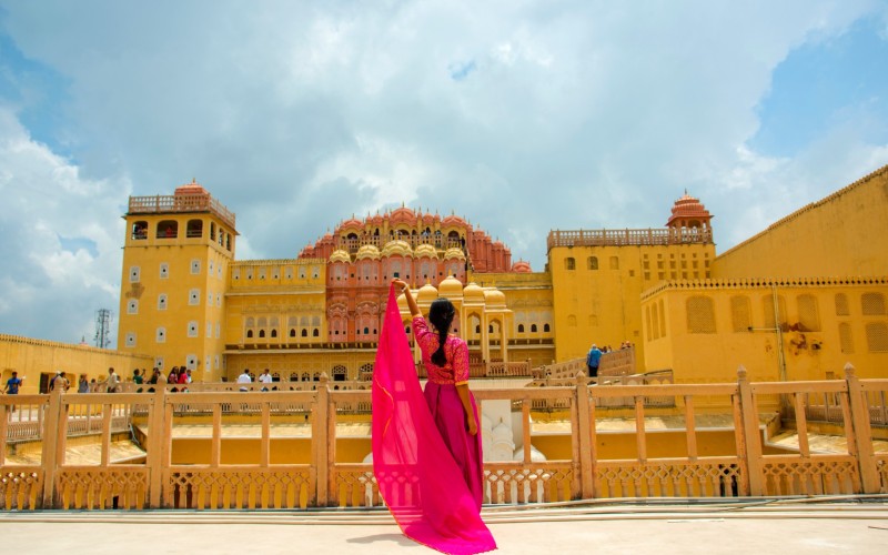Jaipur palace of the wind with woman in colourful sari