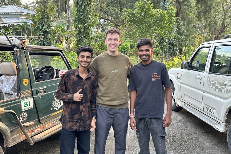 Cameron with guides in Satpura with forest behind