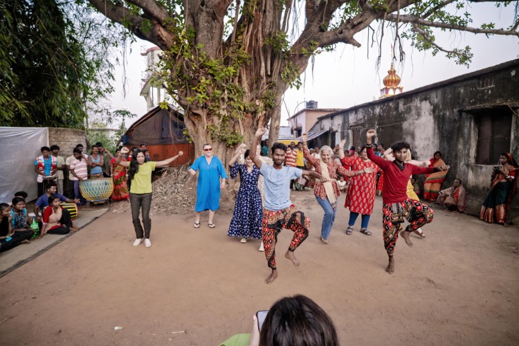 Travellers enjoying The Chhau Festival dancing with a local community
