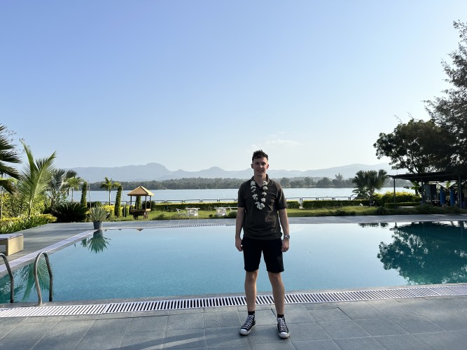 Cameron standing in front of a pool at a resort in Pachmarhi