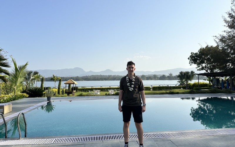 Cameron standing in front of a pool at a resort in Pachmarhi