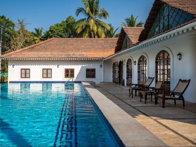 The Postcard Hotel poolside view with palm trees in background
