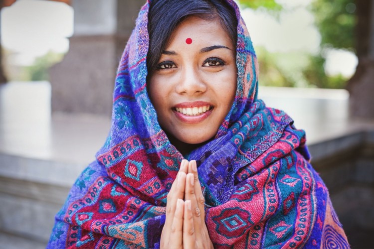 Nepalese woman doing namaste gesture shutterstock