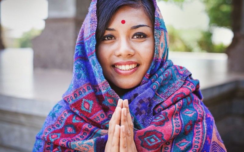 Nepalese woman doing namaste gesture shutterstock