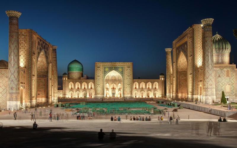 Registan Square lit up in Samarkand at dusk