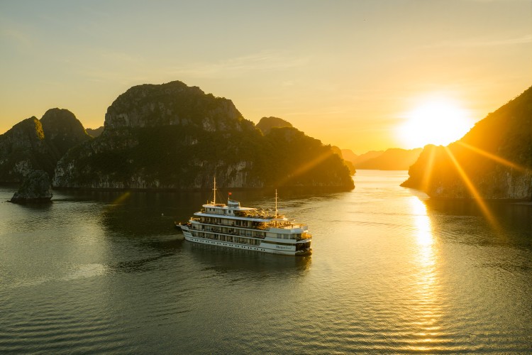 Ha Long Bay sunset cruise with limestone islets in the background