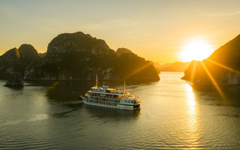 Ha Long Bay sunset cruise with limestone islets in the background