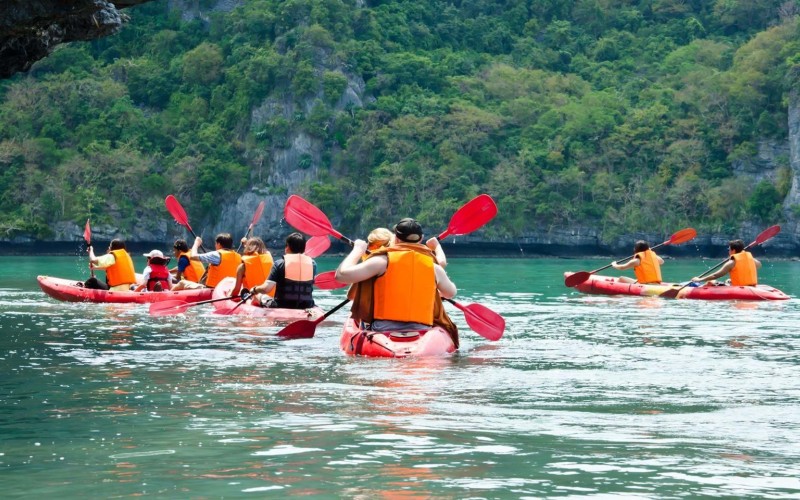 A group is canoeing in clear waters
